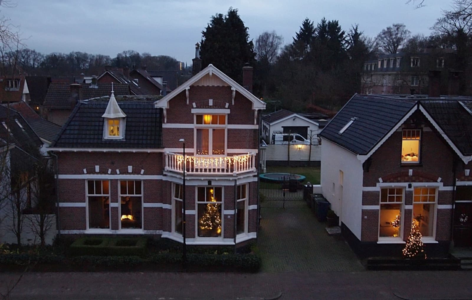 Houses lit up with festive holiday lights in the evening