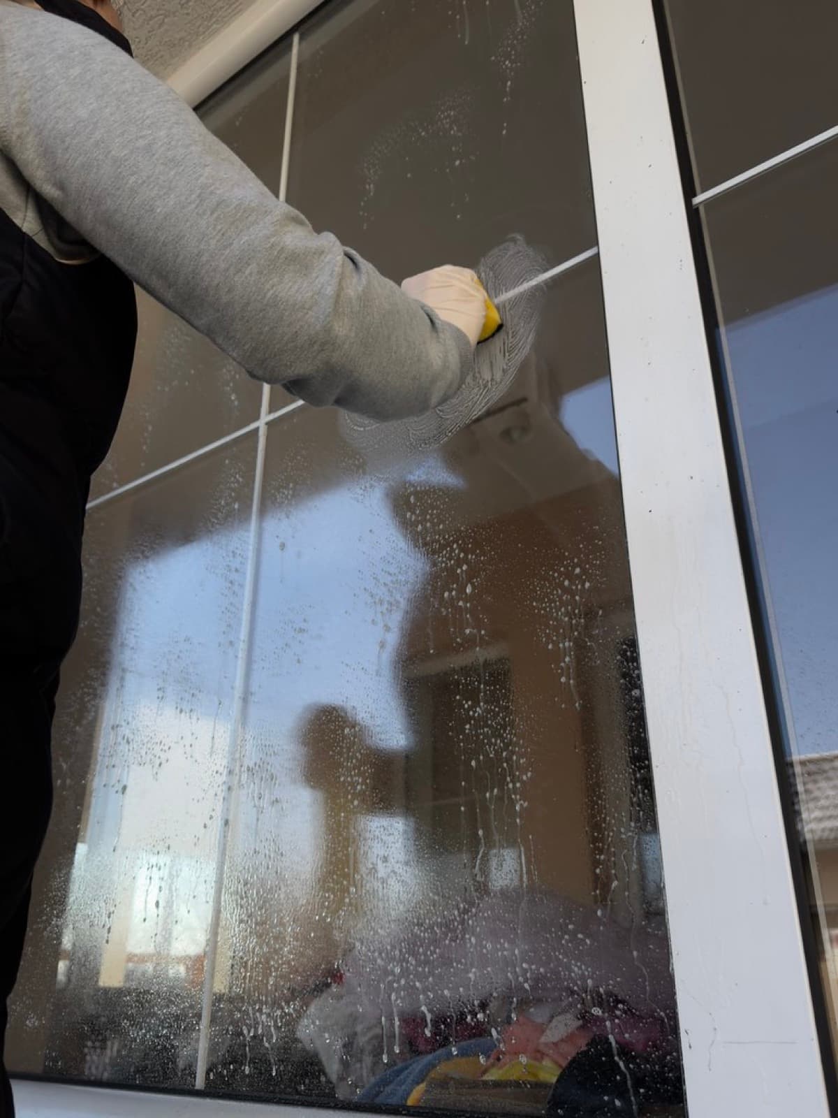 Cleaning a home window to a streak-free finish with a squeegee